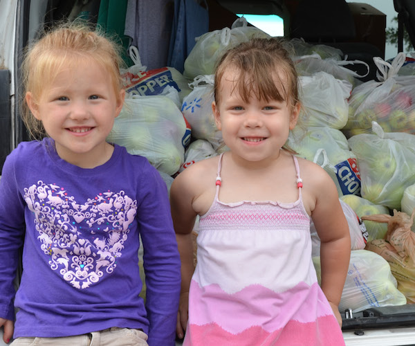 happy girls after gleaning apples